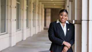 Akaysha Palmer wearing a black blazer outside the Walsh Library.