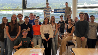 Students from Seton Hall's Stillman School of Business and international students standing in a classroom. 