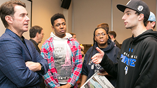 Tom Verducci talks with students after the event