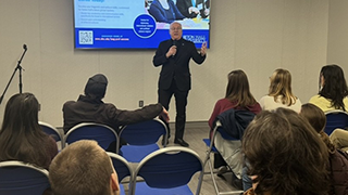 Monsignor Joseph R. Reilly, S.T.L., Ph.D., Seton Hall University President at the February Agape Latte in front of a group of students