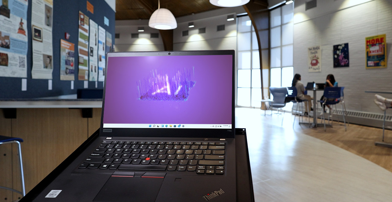 Open laptop displaying 'AI' on the screen in the University Center at Seton Hall's South Orange campus.