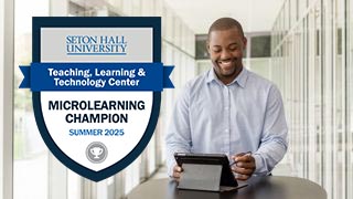 Badge alongside person at a laptop Badge alongside person at a laptop