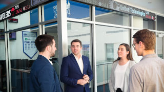 Students talking in front of business department room