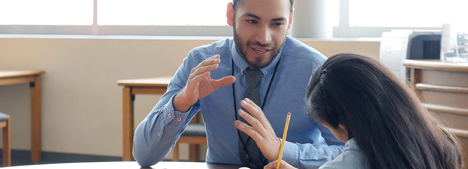 Catholic school educator teaching a young student.