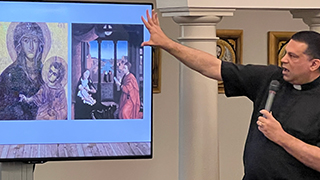 Father Ciriaco describing a painting