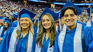 Graduates from the Class of 2025 posing in the Prudential Center at Commencement.