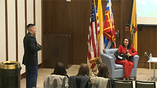 Colonel Chalas Mentorship Colonel Chalas speaking with another military member at an event for the Latino Institute.