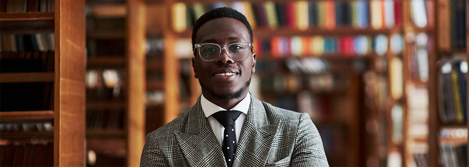 Image of a graduate student and or administrator in a library. 