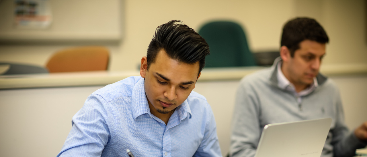 Student taking notes in class