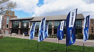 A photo of Giving Day flags on the University Green outside the University Center.