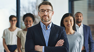 People in business attire standing in formation.