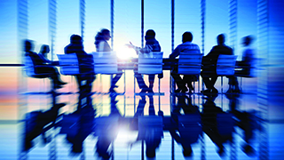 People sitting around a conference table.