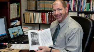 Picture of James Kimble with Rosie the Riveter