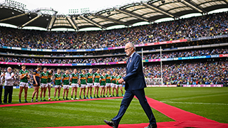 larry mccarthy walks on a red carpet on the stadium to greet players 