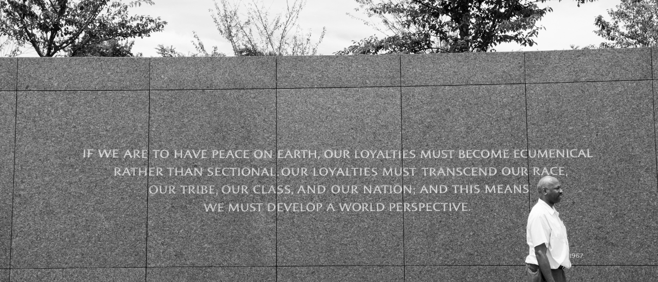 Man beside quote reading: "If we are to have peace on earth, our loyalties must become ecumenical rather than sectional. Our loyalties must transcend our race, our tribe, our class, and our nation; and this means we must develop a world perspective."