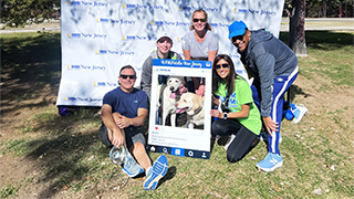 people posing with dog for walk marathon 