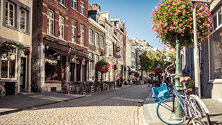 Netherlands city street with a bicycle and shops. 