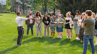 Students gather outdoors for a collaborative class session