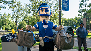Students laughing on bench on campus
