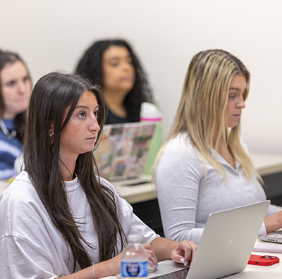 Student taking notes in a Jubilee classroom.
