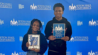 Students Izzy Cesar, a junior Biology major and freshman Dominic McLean man the inagural SHU Blue Fridays table.