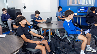 High school sudents listening to Mark Schild present in the Trading Room