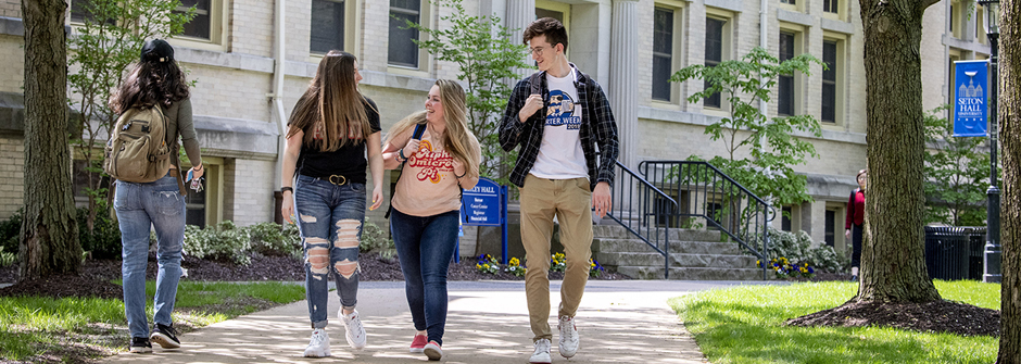 Students walking on campus near Bayley Hall.