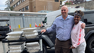 Marc Gordon and Afia of Table to Table with donations for families