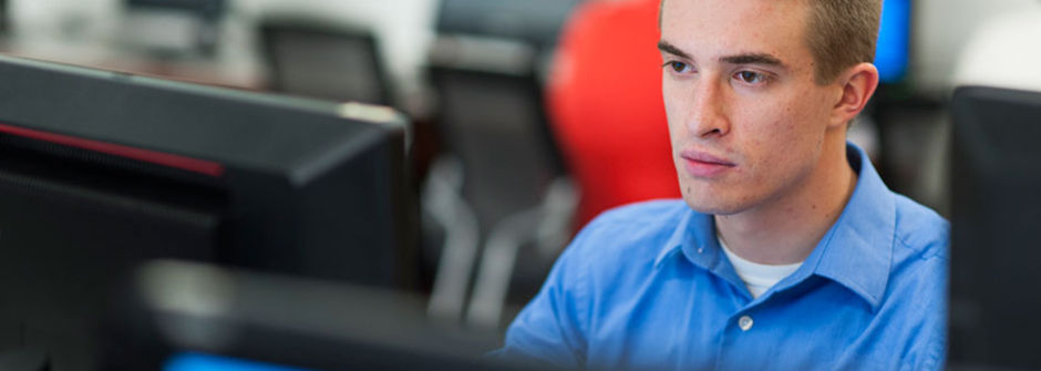 Student working on a computer in a computer lab. 