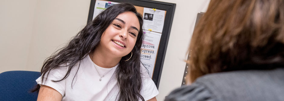 A student speaking with a tutor. 